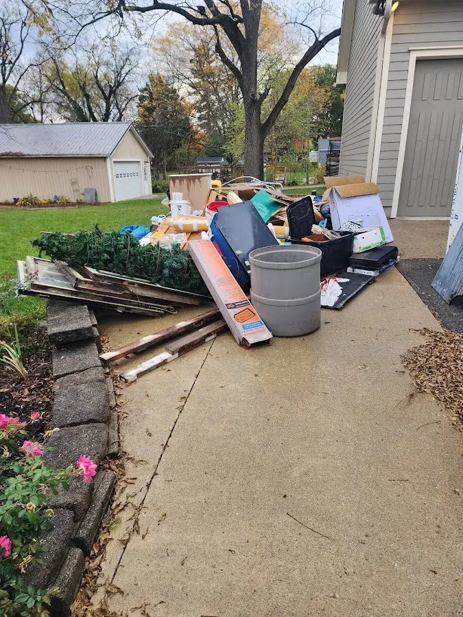 Dumpster being loaded with debris for Estate Cleanout Dumpster Rental in Dumont